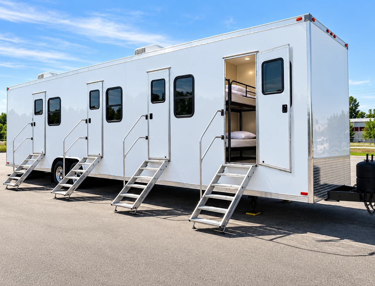White accommodation trailer with separate entrances, steps and a bunk bed visible through an open door